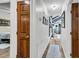 Hallway with dark wood doors, a decorative rug, and a view of the light-filled living spaces at 1705 Sulgrave Rd, Charleston, SC 29414