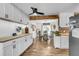 Bright kitchen with white cabinets, butcher block counters, brick accents, and an adjacent dining area at 1705 Sulgrave Rd, Charleston, SC 29414