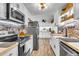 A spacious updated kitchen with stainless appliances, butcher block counters, brick backsplash and white cabinetry at 1705 Sulgrave Rd, Charleston, SC 29414