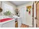 Bright laundry room features modern washer and dryer, window and storage for organization at 1705 Sulgrave Rd, Charleston, SC 29414