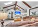 Cozy living room with wood beam ceiling, leather furniture, and a clear view to the kitchen at 1705 Sulgrave Rd, Charleston, SC 29414