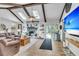 Comfortable living room featuring a fireplace, vaulted ceiling, leather sofa and access to patio at 1705 Sulgrave Rd, Charleston, SC 29414