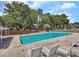 Community pool surrounded by lounge chairs, tables and fence at 1705 Sulgrave Rd, Charleston, SC 29414