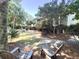 Beautiful backyard with lush greenery, seating, and a fire pit at 1736 James Basford Pl, Mount Pleasant, SC 29466