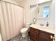 Bathroom with checkered floor, toilet, sink, and vanity with towel rack and shower with curtain at 1736 James Basford Pl, Mount Pleasant, SC 29466