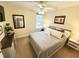 Cozy bedroom features a ceiling fan, bedside tables and lamps, neutral decor, and comfortable queen bed at 1736 James Basford Pl, Mount Pleasant, SC 29466
