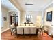 Well-lit dining room with dark wood table and seating for eight, featuring recessed wall niches at 1736 James Basford Pl, Mount Pleasant, SC 29466