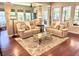 Cozy living area with neutral colored couches, hardwood floors, and view of outdoor landscape at 1736 James Basford Pl, Mount Pleasant, SC 29466