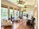 Inviting living room with large windows, hardwood floors, and elegant furnishings at 1736 James Basford Pl, Mount Pleasant, SC 29466