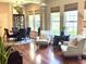 Open-concept living and dining areas with lots of natural light and hardwood flooring at 1736 James Basford Pl, Mount Pleasant, SC 29466