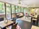 Relaxing screened porch with comfortable seating, dining table, and views of the surrounding nature at 1736 James Basford Pl, Mount Pleasant, SC 29466