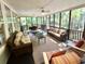 Spacious screened-in porch with comfortable seating, ceiling fans, and view of the outdoors at 1736 James Basford Pl, Mount Pleasant, SC 29466