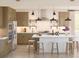 Modern kitchen with stainless steel appliances, a large island, stylish stools, and ample cabinet space at 2034 Mcguire Ln # 009, Hollywood, SC 29449