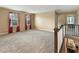 Large, carpeted bonus room with stair access and natural light from multiple windows at 204 Lynx Ln, Summerville, SC 29483