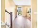 Inviting foyer with wood-look floors, staircase, and a view of the front door leading to a landscaped exterior at 204 Lynx Ln, Summerville, SC 29483