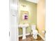 Well-lit half-bathroom with a pedestal sink, modern mirror, and neutral decor at 204 Lynx Ln, Summerville, SC 29483