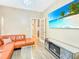 Stylish living room with a comfortable leather sofa, fireplace, and large screen TV at 204 Lynx Ln, Summerville, SC 29483