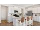 Bright kitchen boasts white cabinets, stainless appliances, and a center island with seating at 206 Belfort Way, Summerville, SC 29486