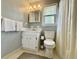 Clean bathroom featuring a white vanity, toilet, and shower with neutral-colored walls at 207 Longstreet St, Summerville, SC 29486