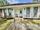 Inviting front porch with a decorative chair and a well-manicured lawn leading to the entrance at 207 Longstreet St, Summerville, SC 29486