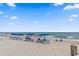 Scenic view of a sandy beach with rows of chairs and umbrellas, overlooking the ocean at 208 Sea Cloud Cir, Edisto Island, SC 29438