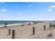 Picturesque beach scene with people relaxing under umbrellas and enjoying the ocean views at 208 Sea Cloud Cir, Edisto Island, SC 29438