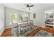 A dining room featuring a table set for six, bright windows, and hardwood floors at 208 Sea Cloud Cir, Edisto Island, SC 29438