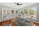 A bright dining room featuring a table set for six and a wall of bright windows at 208 Sea Cloud Cir, Edisto Island, SC 29438