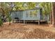Exterior showing this home's raised foundation with a wooded surrounding at 208 Sea Cloud Cir, Edisto Island, SC 29438