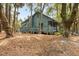 Charming exterior of home with a surrounding deck nestled in a wooded lot at 208 Sea Cloud Cir, Edisto Island, SC 29438