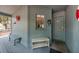 Inviting covered front porch with bench seating, decor, and front door access at 208 Sea Cloud Cir, Edisto Island, SC 29438