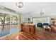 A beautifully decorated living room flows out onto a patio and features hardwood floors at 208 Sea Cloud Cir, Edisto Island, SC 29438