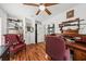 A home office featuring wood floors, desk, shelving, and ample storage at 208 Sea Cloud Cir, Edisto Island, SC 29438
