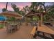 Inviting outdoor patio area featuring a covered pergola, picnic tables, and seating, perfect for gatherings at 208 Sea Cloud Cir, Edisto Island, SC 29438