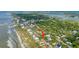 Aerial view of the house, beach access, and a canopy of trees from the surrounding area at 220 E Arctic Ave, Folly Beach, SC 29439