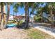 Spacious backyard featuring a pool, mature trees, and lush greenery, offering a serene outdoor retreat at 220 E Arctic Ave, Folly Beach, SC 29439