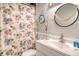 Bathroom featuring a vanity sink, shell-themed shower curtain and seaside decor at 220 E Arctic Ave, Folly Beach, SC 29439