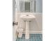 Charming powder room featuring a pedestal sink and unique blue patterned tile floor at 220 E Arctic Ave, Folly Beach, SC 29439