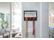 Entryway with 'Beach House' sign, hooks, and a glimpse of the living room and patio at 220 E Arctic Ave, Folly Beach, SC 29439
