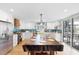 Bright kitchen features a dining table and an island with modern appliances and stylish backsplash at 220 E Arctic Ave, Folly Beach, SC 29439