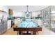 Open-concept kitchen featuring a pool table as a centerpiece, white cabinetry, and stainless steel appliances at 220 E Arctic Ave, Folly Beach, SC 29439