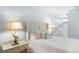 Bedroom featuring a white bed, beach-themed decor, and a connected bathroom at 220 E Arctic Ave, Folly Beach, SC 29439