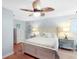 Charming bedroom with a leaf-design ceiling fan, white furniture, and light blue walls at 220 E Arctic Ave, Folly Beach, SC 29439