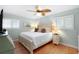 Bedroom featuring a white bed, leaf-design ceiling fan, and light green walls at 220 E Arctic Ave, Folly Beach, SC 29439