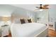 Bedroom featuring a white bed, leaf-design ceiling fan, and light green walls at 220 E Arctic Ave, Folly Beach, SC 29439