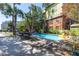 Backyard swimming pool surrounded by palm trees, creating a private and tropical oasis at 220 E Arctic Ave, Folly Beach, SC 29439