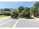 Street view showcasing the community information board surrounded by lush greenery and colorful flowers at 220 E Arctic Ave, Folly Beach, SC 29439