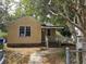 Modest home featuring a ramp to the front door, framed by mature trees at 2313 Aintree Ave, North Charleston, SC 29405