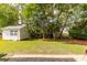 Well-maintained backyard with green grass, mature trees, and a storage shed for added convenience at 2632 Planters Pointe Blvd, Mount Pleasant, SC 29466