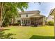 Spacious backyard featuring a patio, screened porch, lush lawn, and mature trees, perfect for outdoor activities at 2632 Planters Pointe Blvd, Mount Pleasant, SC 29466